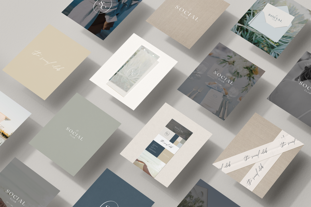 A flat lay of various pastel-colored business cards and brochures with minimalist designs and the word SOCIAL or handwritten script, arranged neatly on a light surface.