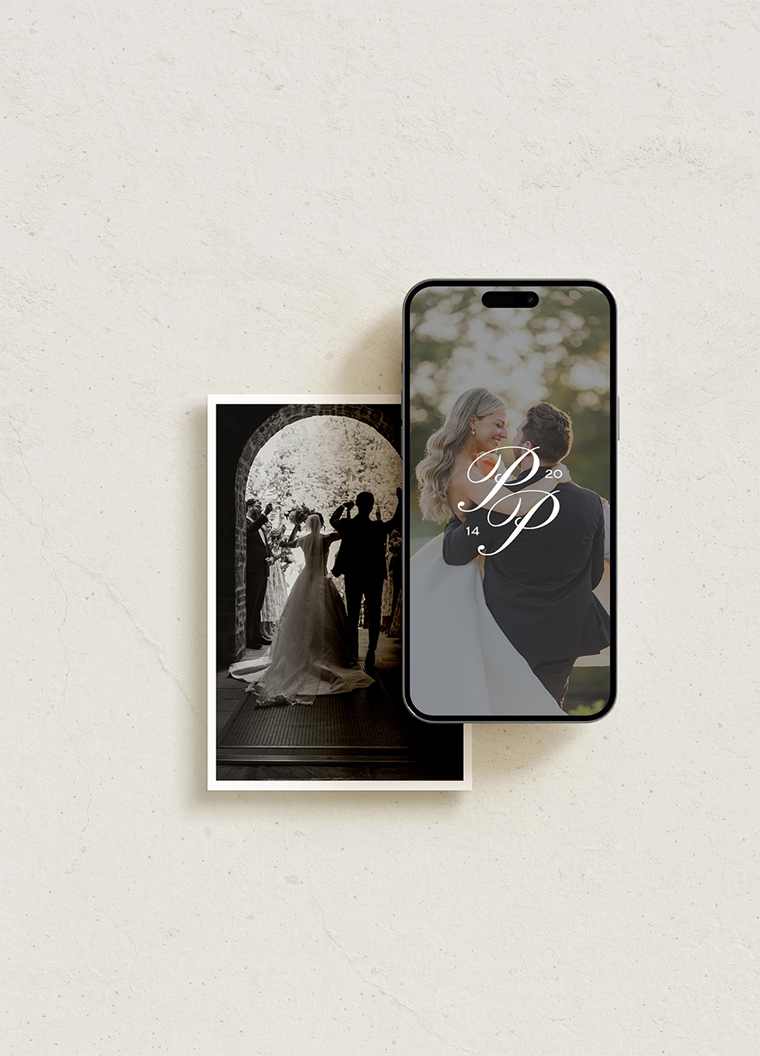 A black-and-white photo of a newlywed couple walking under a floral arch is placed next to a smartphone displaying a color photo of the couple embracing, with elegant white initials and a date overlay.